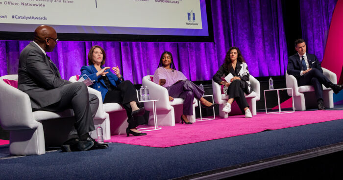 panel of speakers conversing on stage at catalyst awards