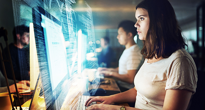 Shot of a programmer working on a computer code at night