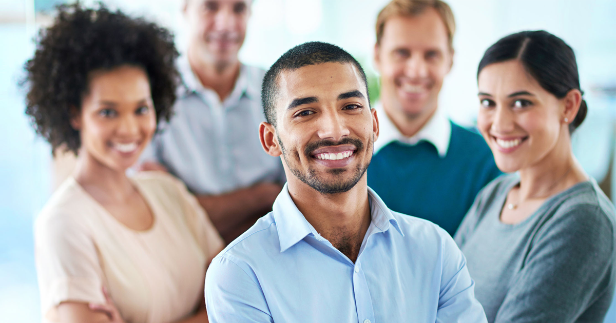 Cropped portrait of a group of diverse colleagues standing in their office against a digitally enhanced background